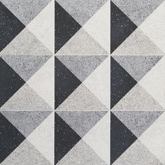 black and white tiles are arranged in the shape of an argyle pattern, with speckles