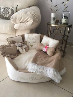 a chair with pillows and stuffed animals on it