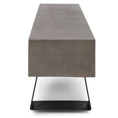 a concrete table sitting on top of a black metal stand with one leg up and the other end down