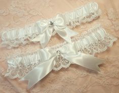 "Handcrafted wedding garter set. Created w/ white satin and white lace. Centered w/ white satin bow and clear rhinestone. Garters stretch comfortably up to and at 22\". Personalization is available for an additional fee. Please leave the names and date in the box provided. If you would like a personalized ribbon for BOTH garters, please choose the personalized option in the drop down menu for your main garter, then add this to your purchase for the second garter... https://www.etsy.com/shop/Gart Thigh Choker, Wedding Garder, Cow Halloween Costume, White Garter Belt, Leg Garters, Clothing Board, White Garters, Wedding Garter Lace, Leg Garter