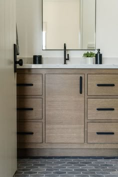 a bathroom vanity with two sinks and a large mirror