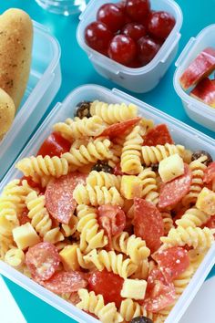 there are many different types of food in the trays on the blue tablecloth