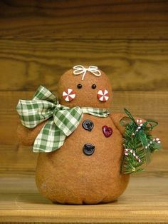 a small brown snowman sitting on top of a wooden shelf