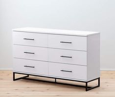 a white dresser sitting on top of a hard wood floor