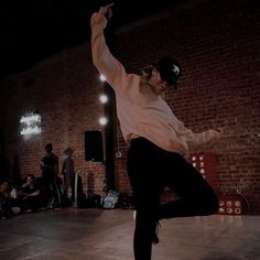 a young man is doing a trick on his skateboard in the middle of a dance class