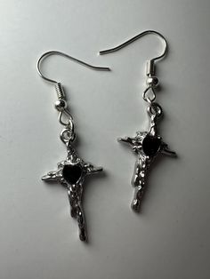 This handmade pair of earrings features a beautiful silver set of melted cross pendants. Perfect for everyday wear or special occasions! May not be best suited for water wear* Metal Cross Pendant Earrings For Gift, Metal Cross Pendant Earrings As Gift, Silver Nickel-free Cross Pendant Earrings, Silver Metal Cross Pendant Earrings, Silver Cross Pendant Earrings, Nickel-free, Silver Cross Pendant Earrings, Nickel Free, Silver Cross Pendant Pierced Earrings, Handmade Metal Cross Earrings, Silver Cross Pendant Earrings