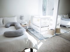 a baby crib in the corner of a room with white walls and flooring