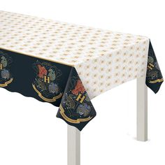 a harry potter themed tablecloth with hogwarts symbols on the front and back