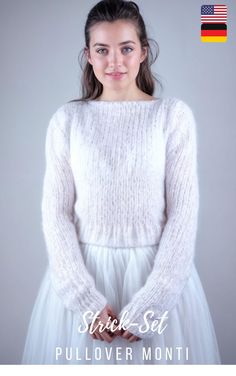 a woman in a white sweater and tulle skirt with her hands on her hips