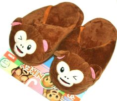 a pair of monkey slippers sitting on top of a children's toy book