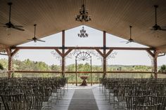 an outdoor venue with rows of chairs and chandeliers