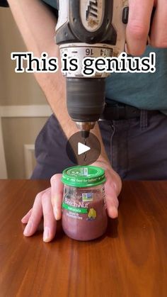 a man is using a driller on a table to make something brown and pink