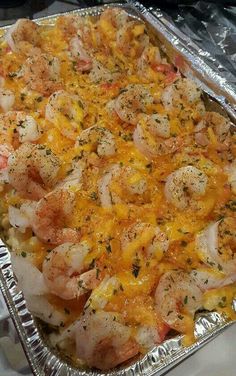 a casserole dish with shrimp and cheese on it