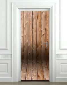 an open wooden door in a white room