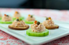 small appetizers are arranged on a white plate