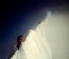 a man is skiing down the side of a snow covered mountain with his skis on