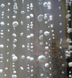 the window is covered with white balls and snowflakes