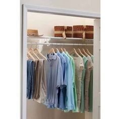 an open closet with clothes and baskets on the shelves next to it is a white door