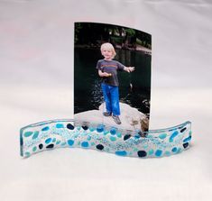 a card with a photo of a boy standing on a rock