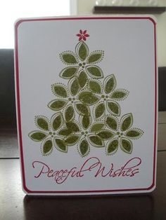 a card with a christmas tree on it and the words peaceful wishes written in red