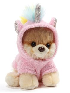 a small stuffed animal wearing a pink outfit with a unicorn horn on it's head