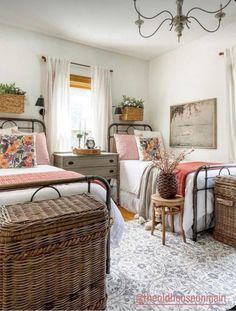 a bedroom with two beds and baskets on the floor