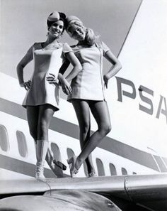 two women standing on the wing of an airplane