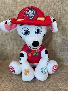 a stuffed dog wearing a fireman's hat