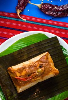 a plate with some food on top of it next to a red and blue table cloth