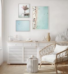 an empty white room with a chair, table and large mirror on the wall above it