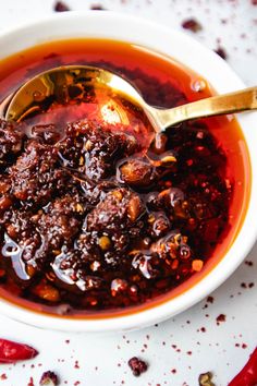 a white bowl filled with red chili sauce