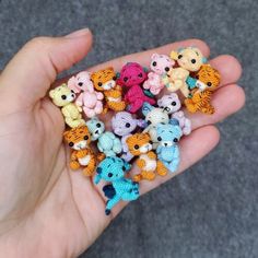 small crocheted animals are being held in the palm of someone's hand