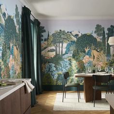 the dining room is decorated with colorful wallpaper