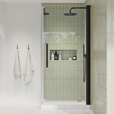 a bathroom with two towels hanging on the wall next to a shower stall and sink