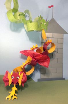 a paper sculpture of two sea creatures in front of a house