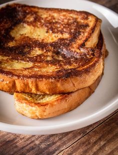 two pieces of french toast on a white plate