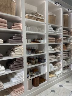 the shelves are filled with towels and other items