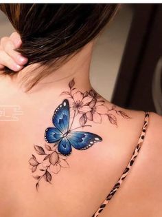 a woman with a blue butterfly tattoo on her back