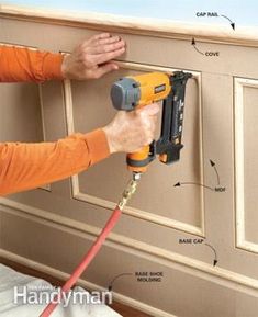 a man using a power drill to attach a wall panel