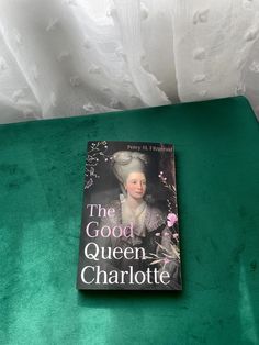 a book sitting on top of a green table next to a white bedding sheet