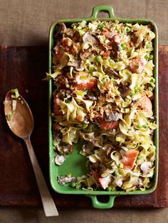 a green casserole dish with meat and vegetables