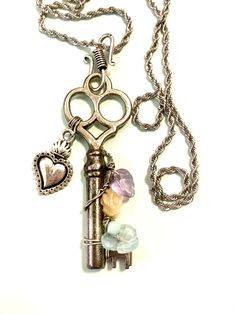 an old key with some charms attached to it