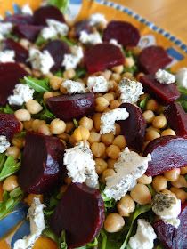 beet and chickpeas salad with feta cheese on yellow plate, closeup