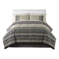 a bed with grey and white comforter set