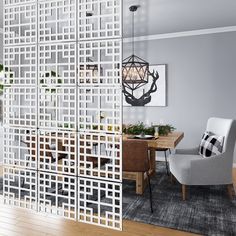 a room divider in the middle of a living room with a dining table and chairs