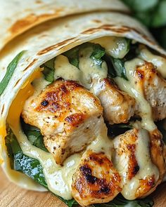 chicken and spinach wrap on a cutting board