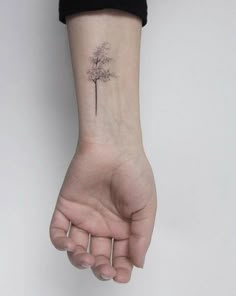 a small tree tattoo on the wrist