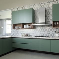 a modern kitchen with green cabinets and white counter tops, along with a clock on the wall