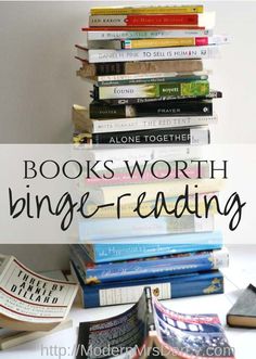 a stack of books sitting on top of a table next to a pile of books