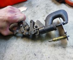 a man is working on some metal parts that are attached to the handlebars